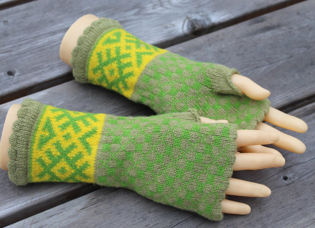 Green and yellow patterned fingerless gloves on a wooden surface