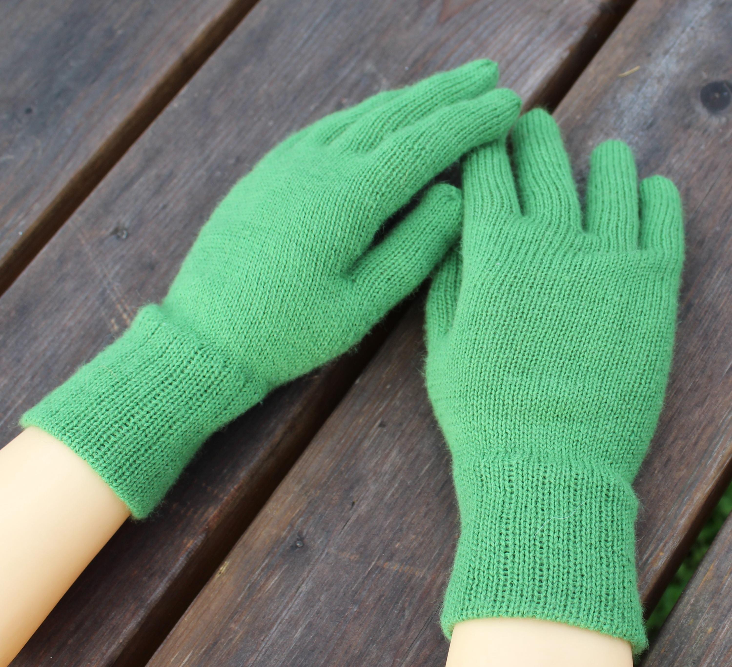 Green gloves on a wooden surface