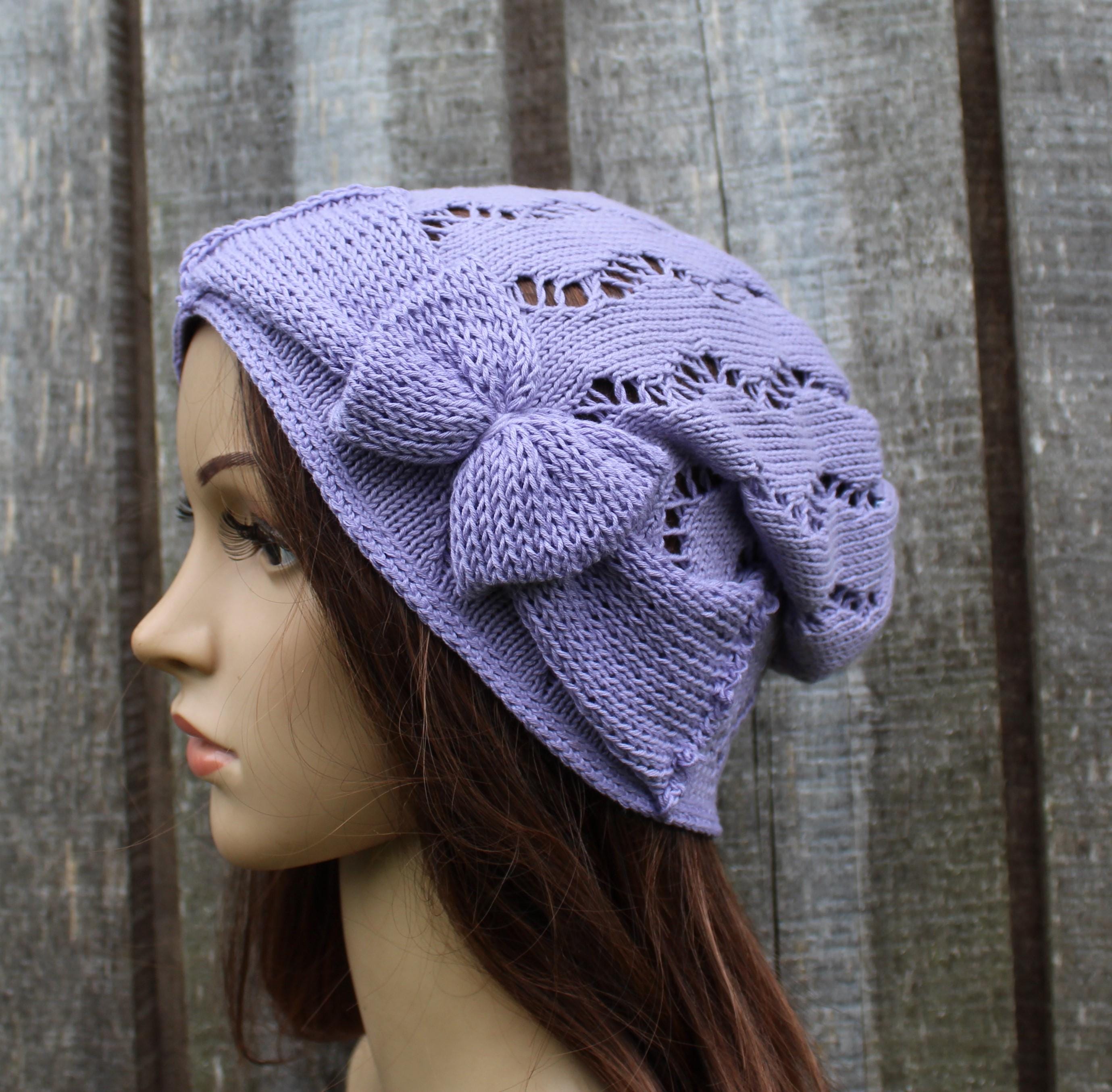 Lavender knit headband on a mannequin head against a wooden background