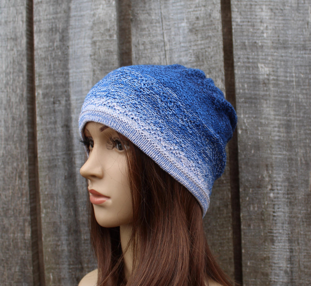 Blue knitted beanie on a mannequin head against a wooden background