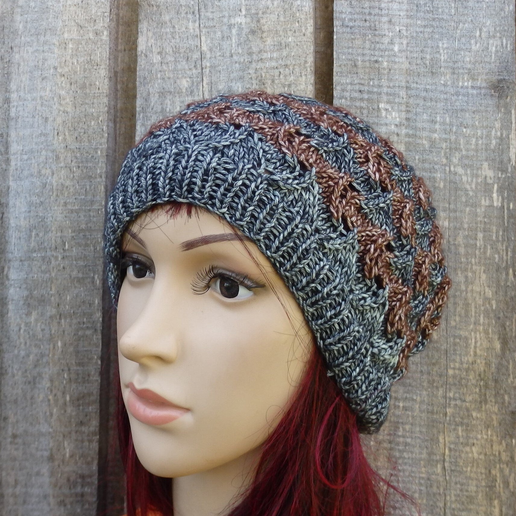 Knitted beanie on a mannequin head against a wooden background