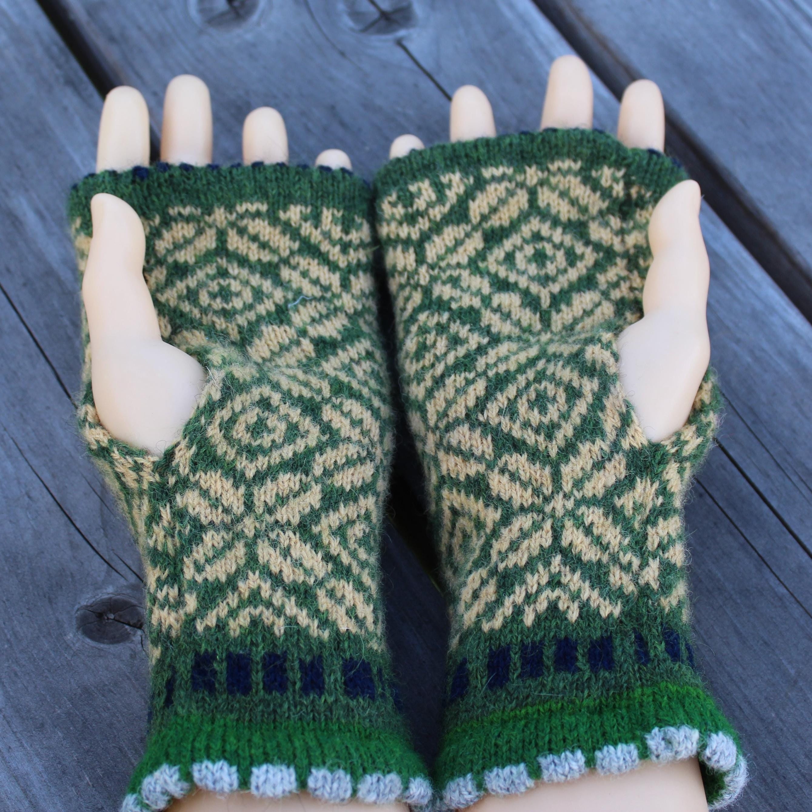 Green and yellow wool arm warmers held on a wooden surface