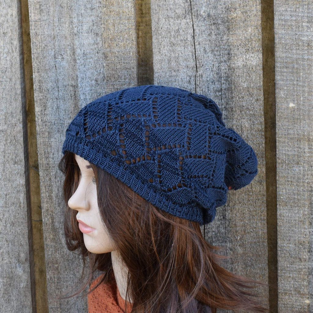 Woman wearing a blue knitted hat against a wooden background