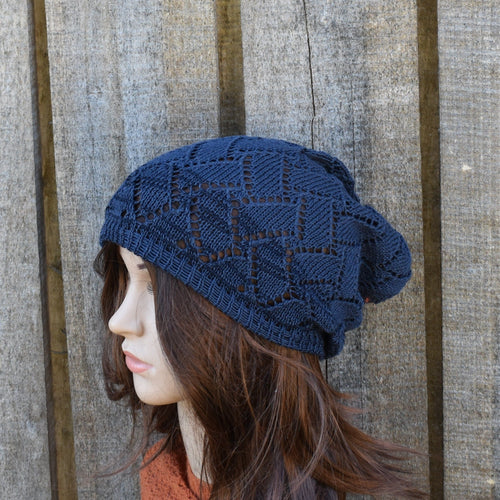 Woman wearing a blue knitted hat against a wooden background