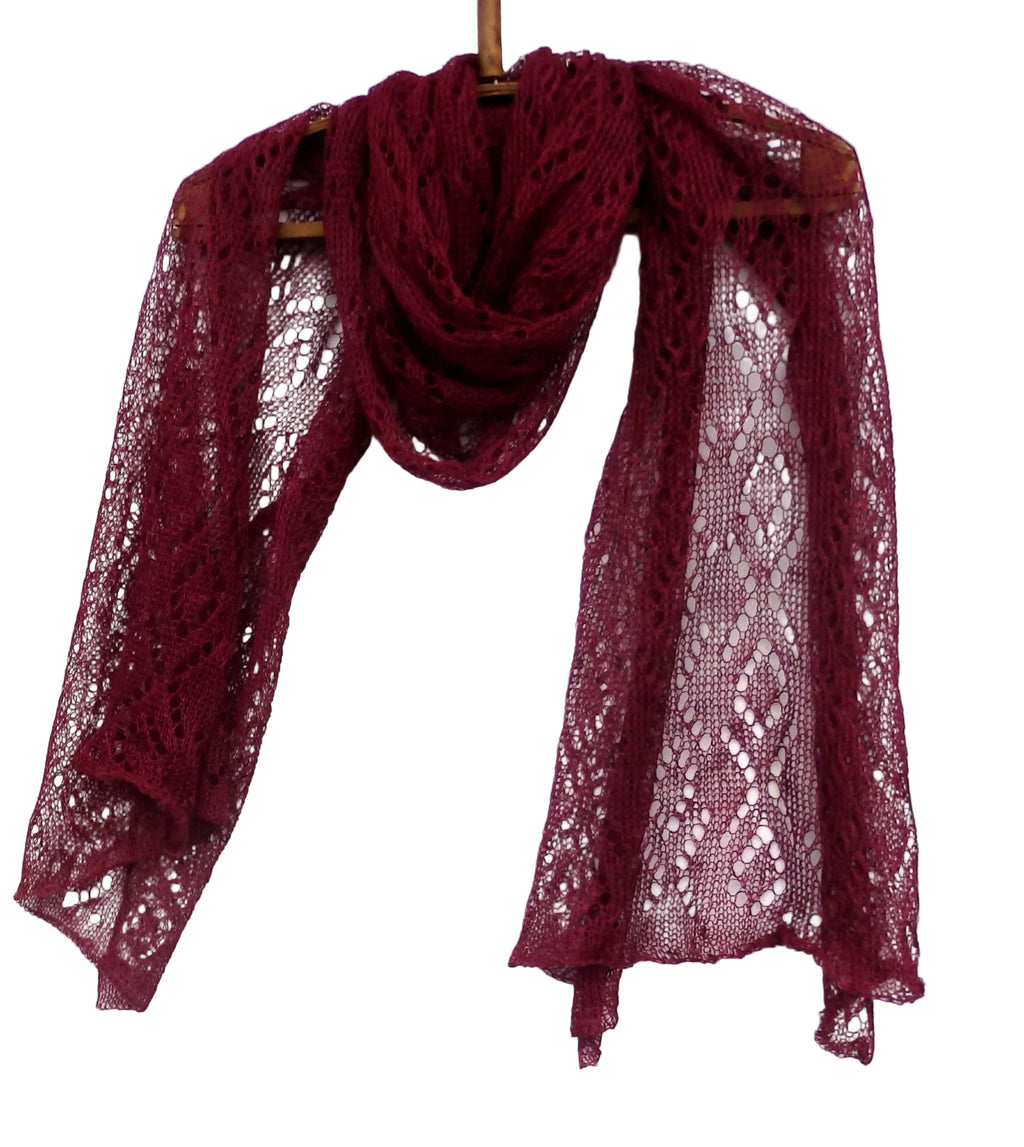 Maroon lace scarf on a wooden hanger against a white background