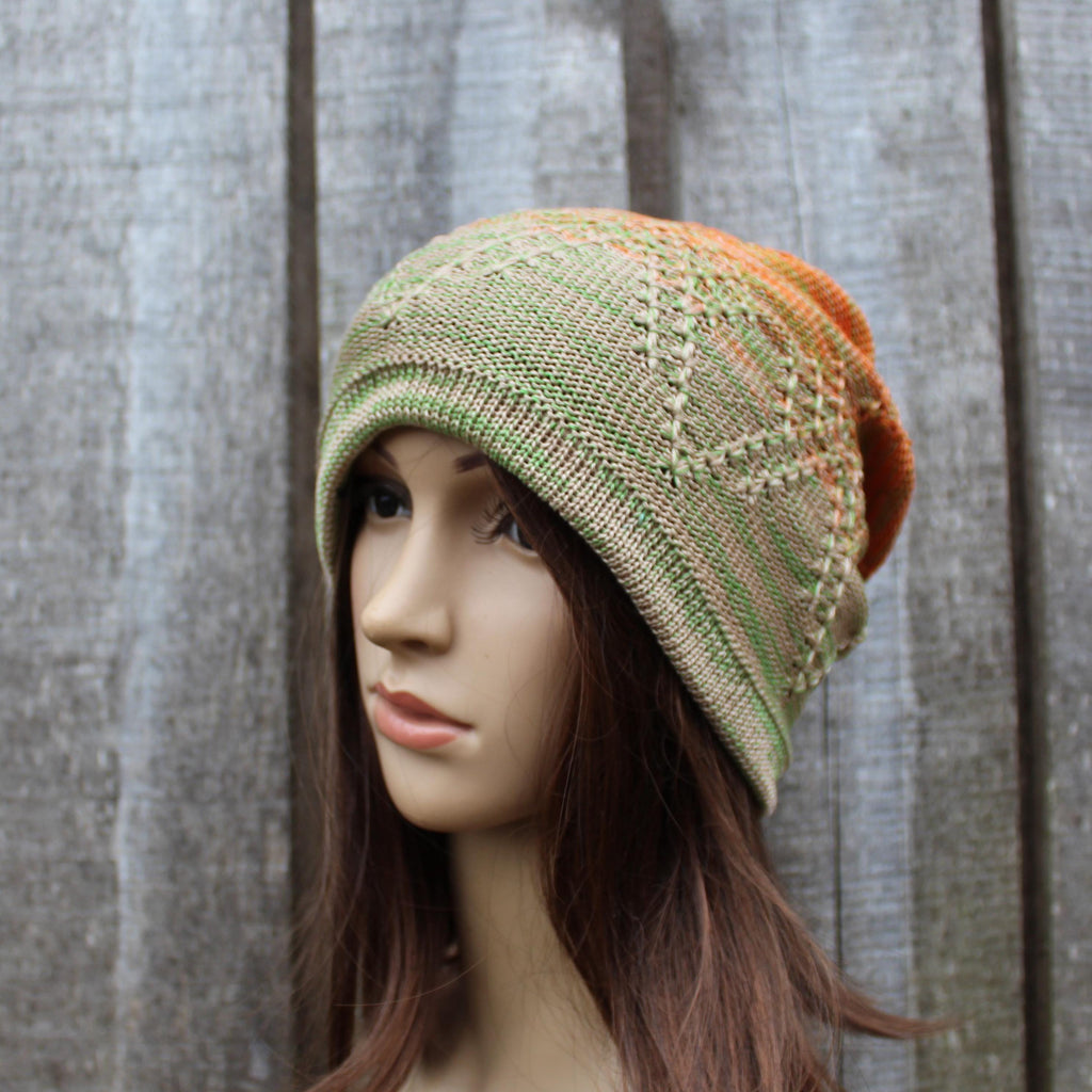 Knitted hat on a mannequin head against a wooden background