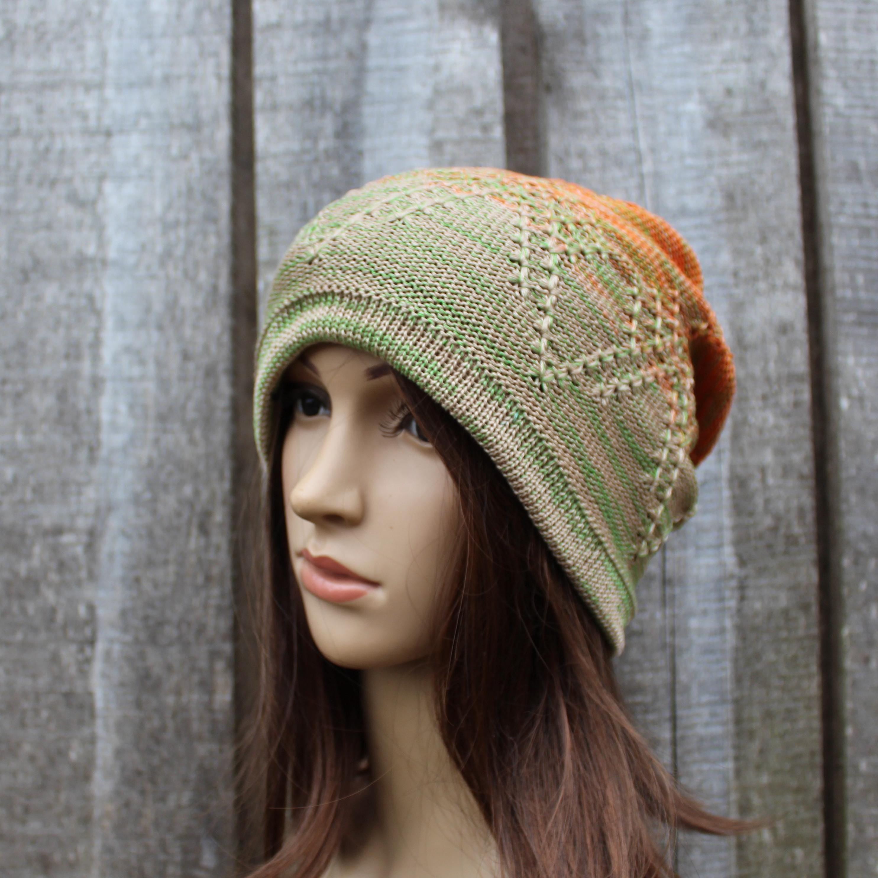 Knitted hat on a mannequin head against a wooden background