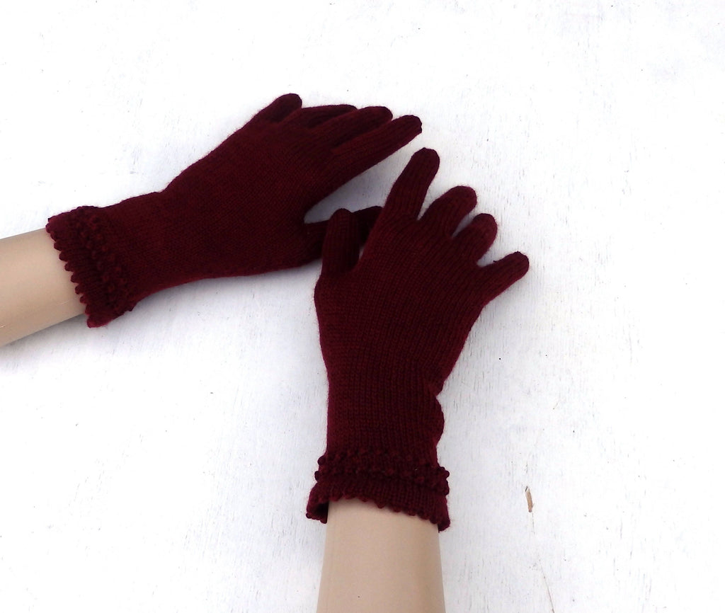 Pair of maroon gloves on a white background