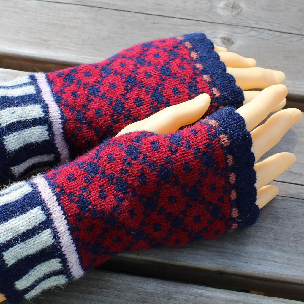Red and blue patterned fingerless gloves on a wooden surface