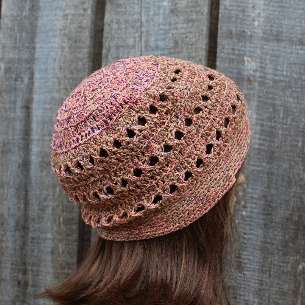 Knitted cotton beanie worn by a person against a wooden background