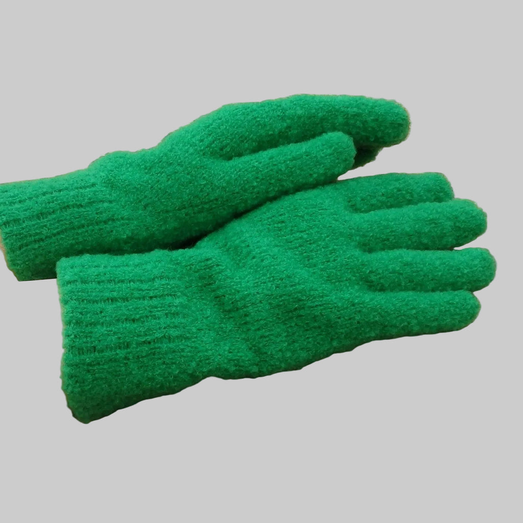 Green gloves on a person's hands on a woven mat background