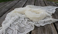 White lace shawl on a wooden surface