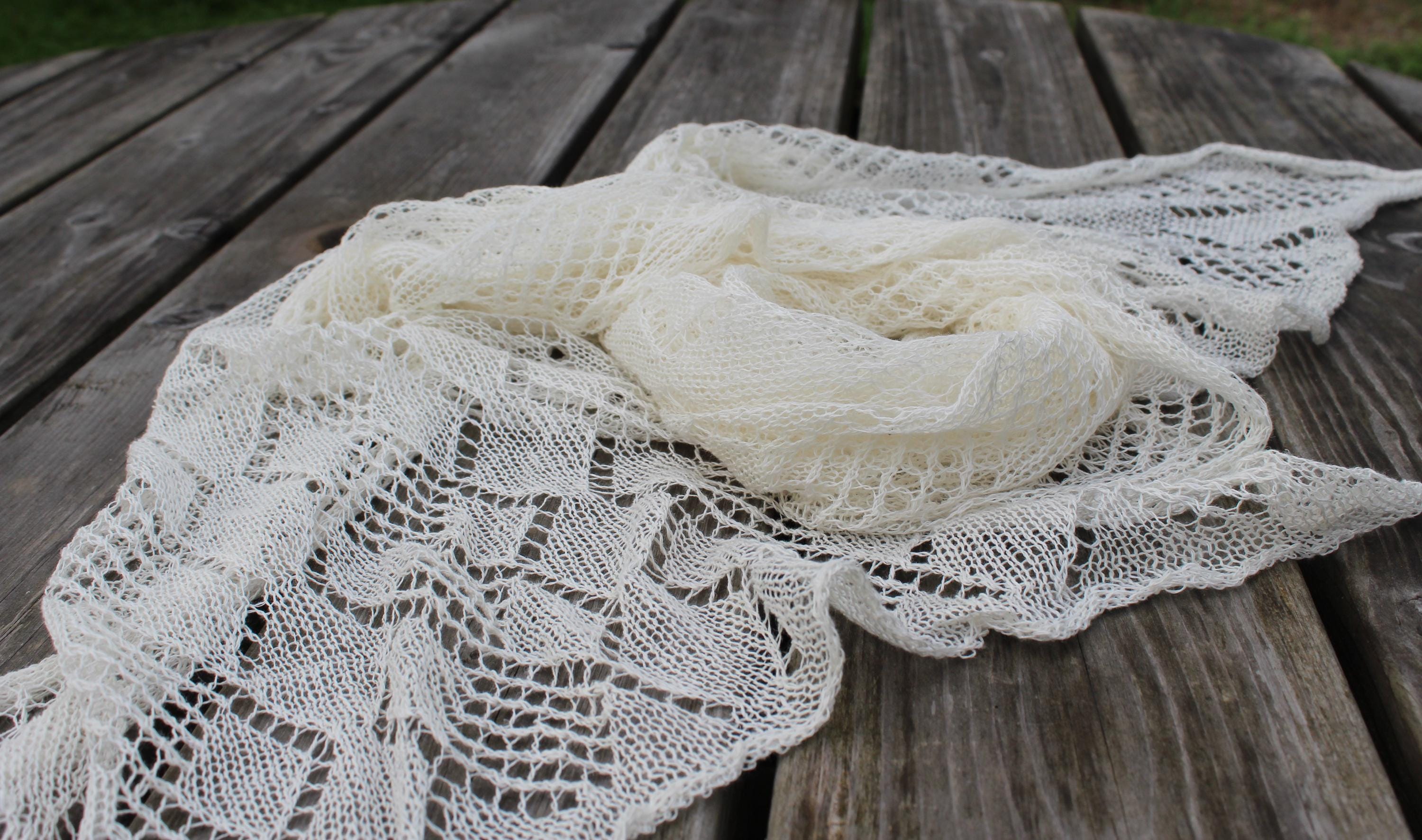 White lace shawl on a wooden surface