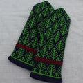 Green and black patterned gloves on a gray background