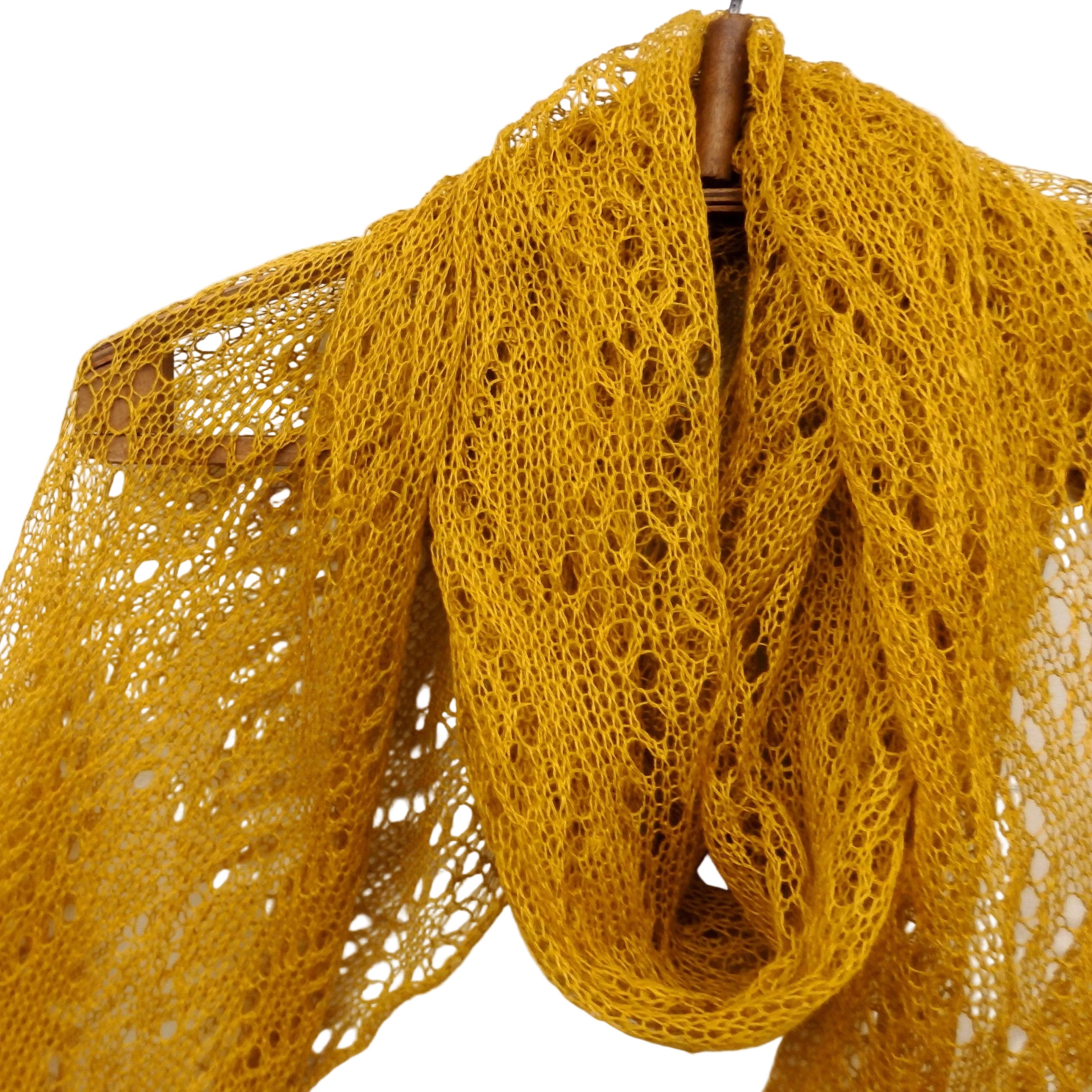 Mustard yellow knitted shawl on a white background