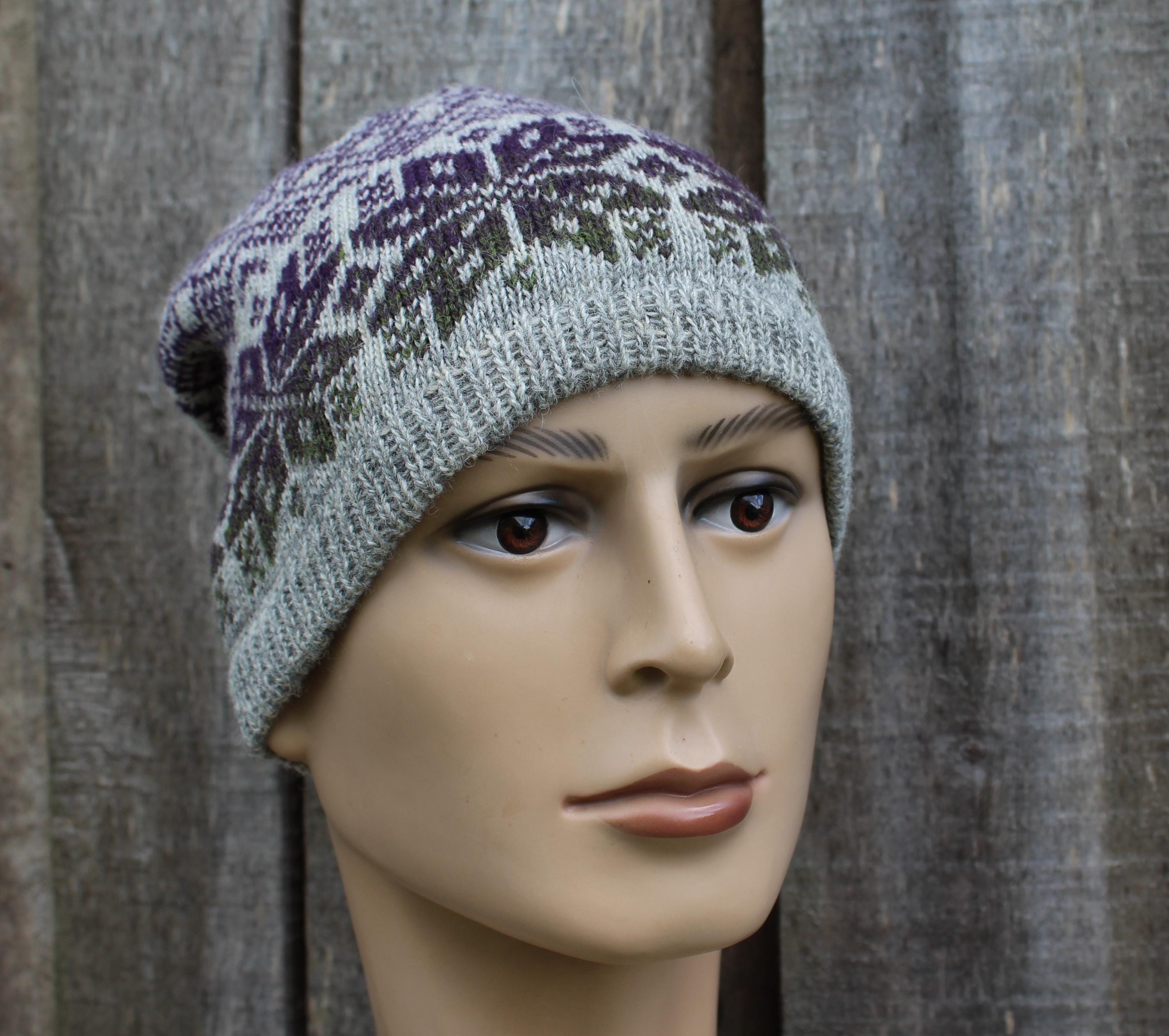 Knitted hat with a pattern on a mannequin head against a wooden background