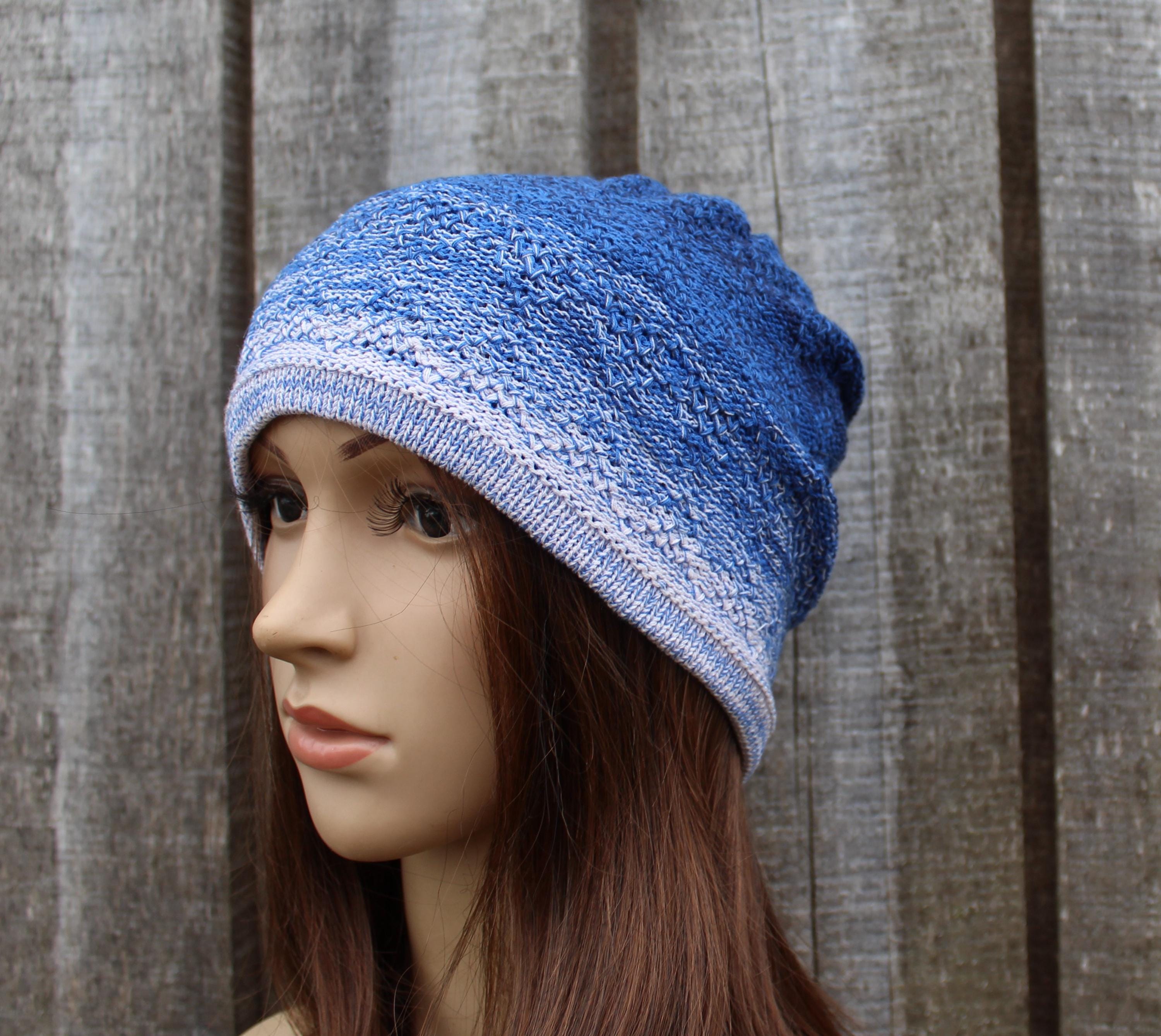 Blue knitted beanie on a mannequin head against a wooden background