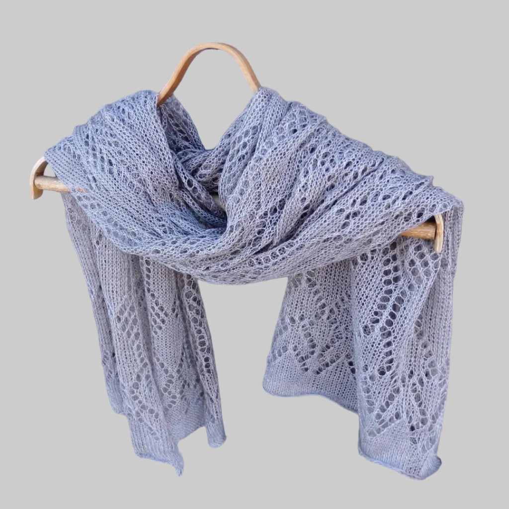 Gray lace scarf on a wooden hanger against a wooden background