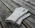 Pair of gray gloves on a wooden surface