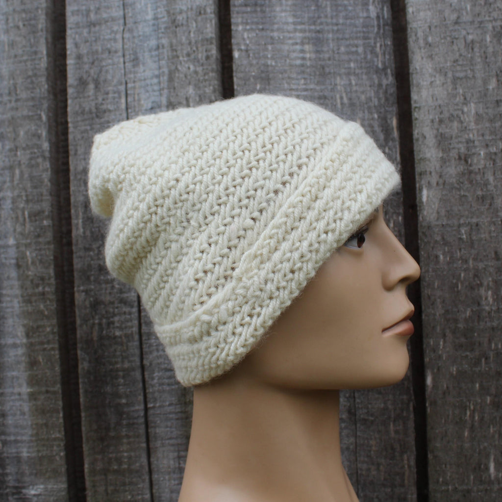 Naalbinding beanie on a mannequin head against a wooden background