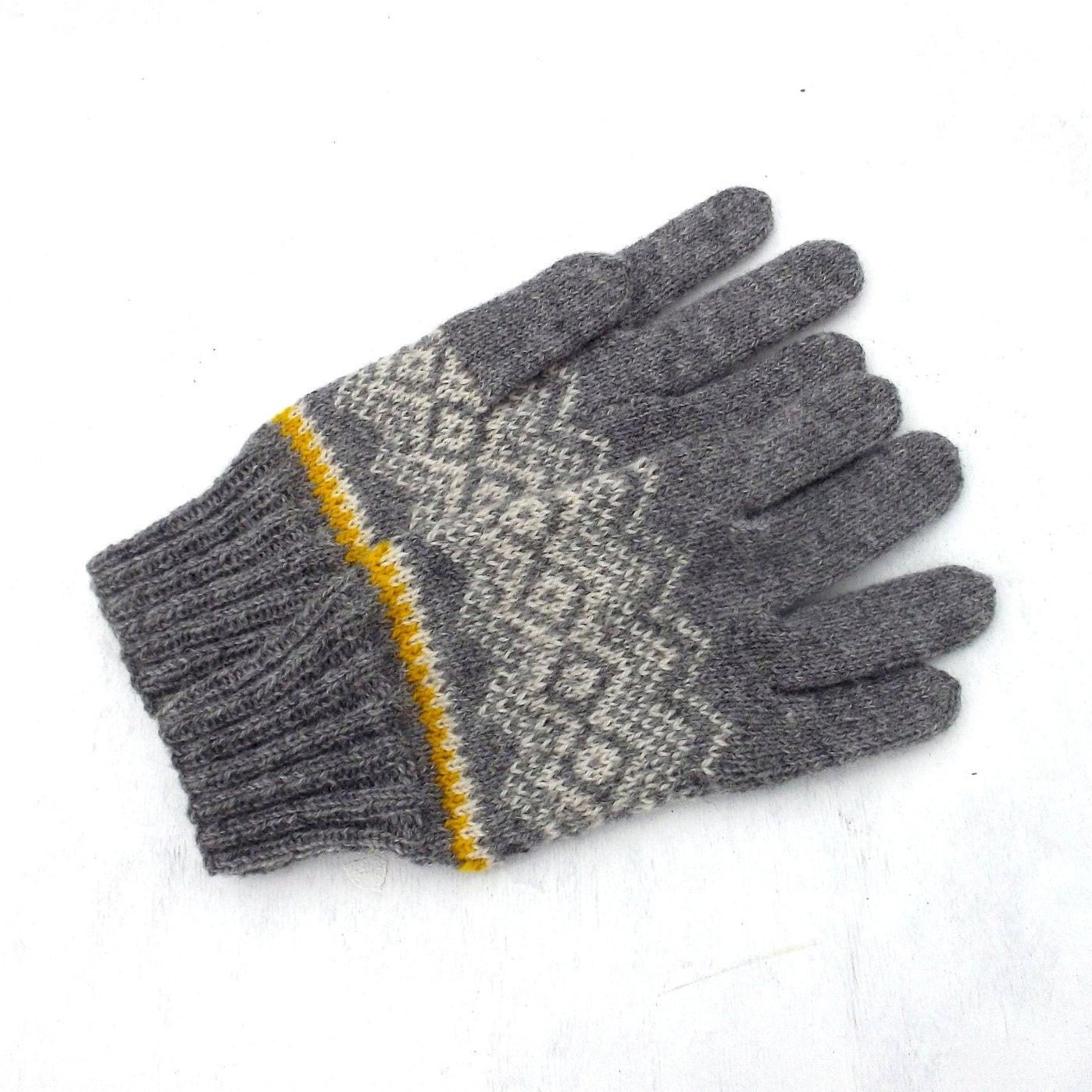 Gray gloves with a patterned palm and yellow trim on a white background