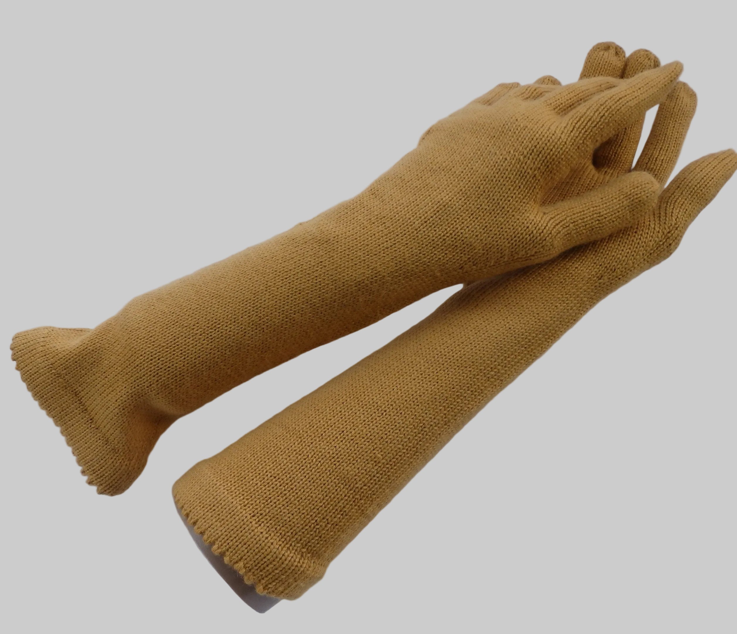 Pair of mustard yellow gloves on a white background