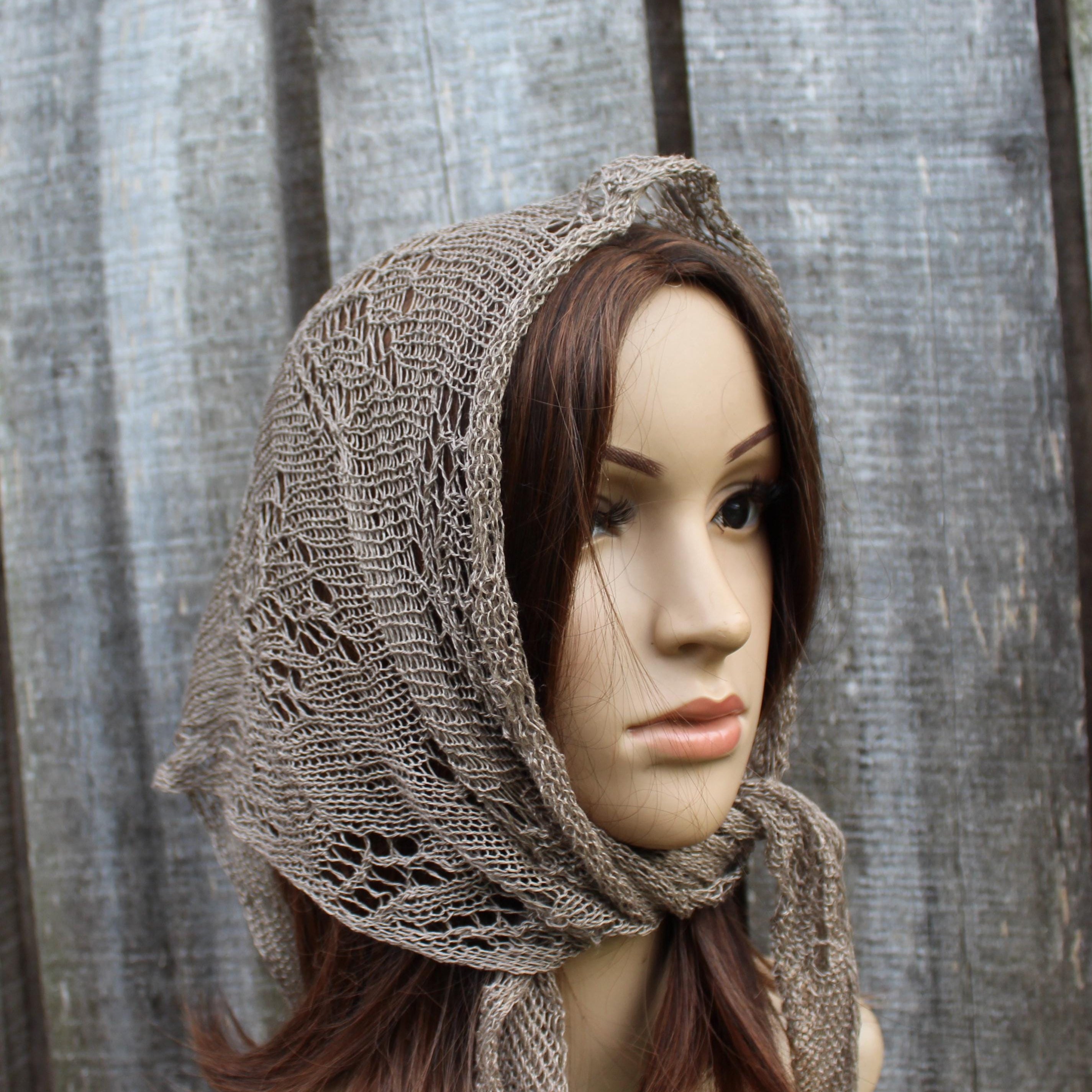 Mannequin head wearing a brown knitted  triangle linen headscarf 