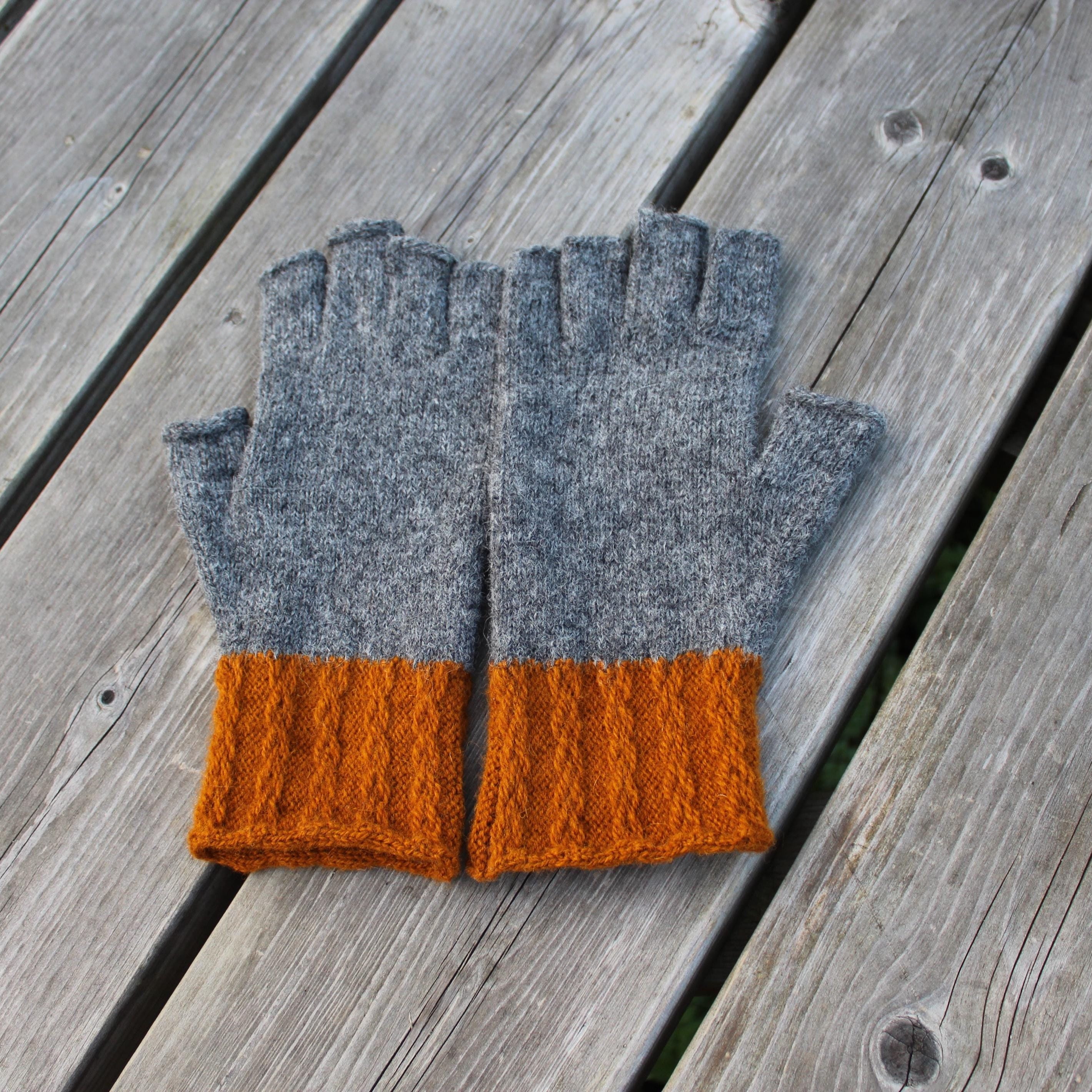 Gray and orange fingerless gloves on a wooden surface