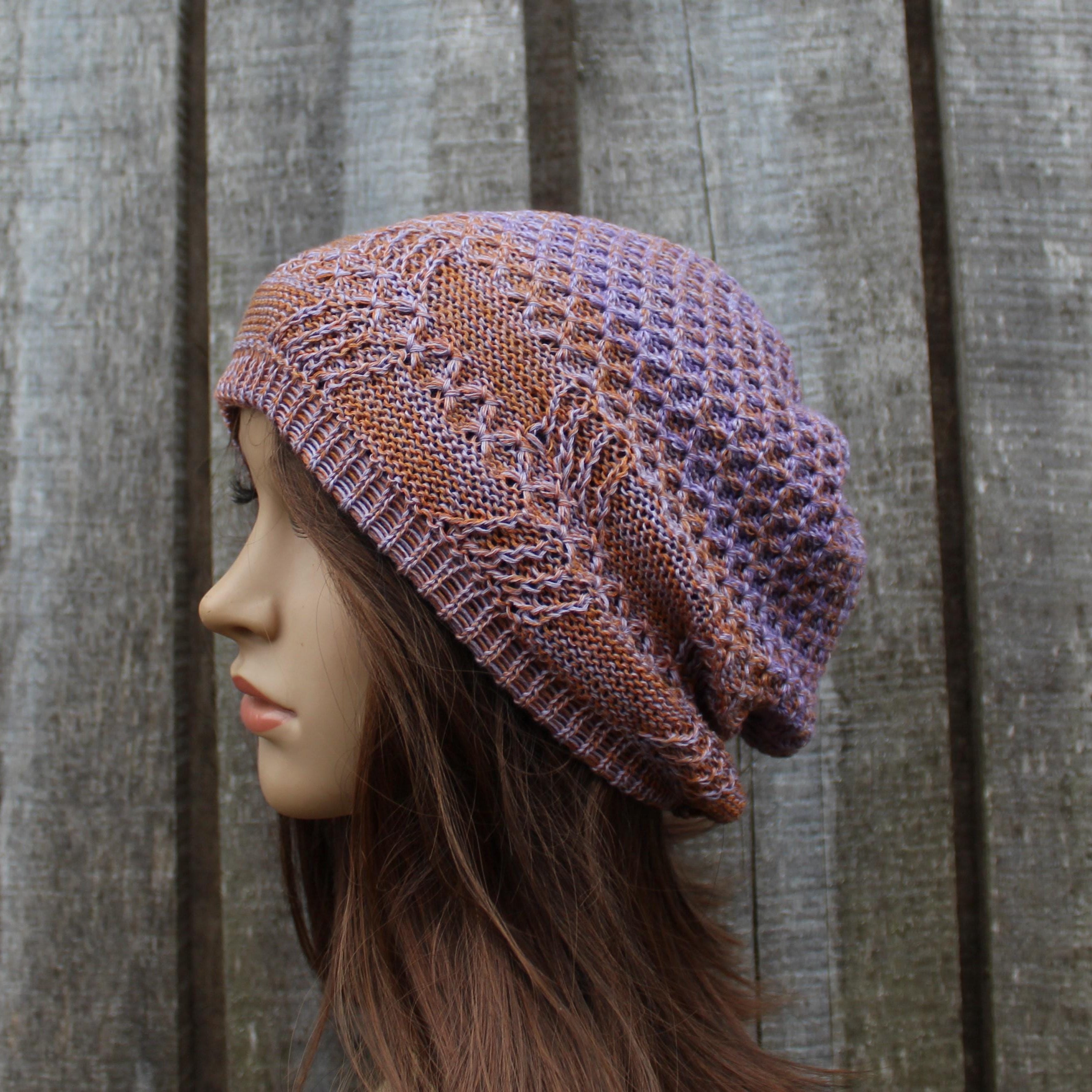 Knitted hat on a mannequin head against a wooden background