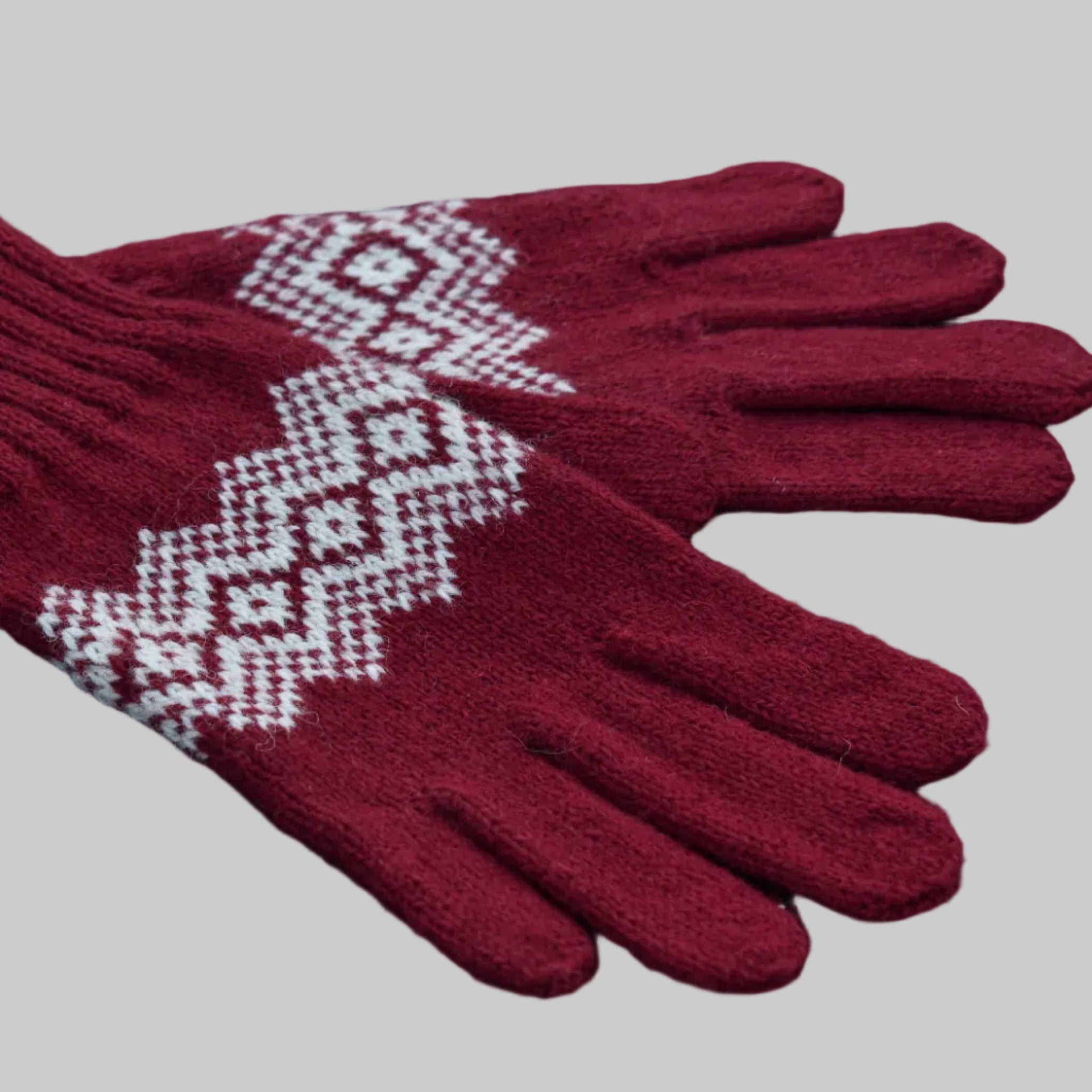 Red gloves with white pattern on a black background