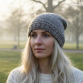 Woman wearing a knitted beanie in a park setting