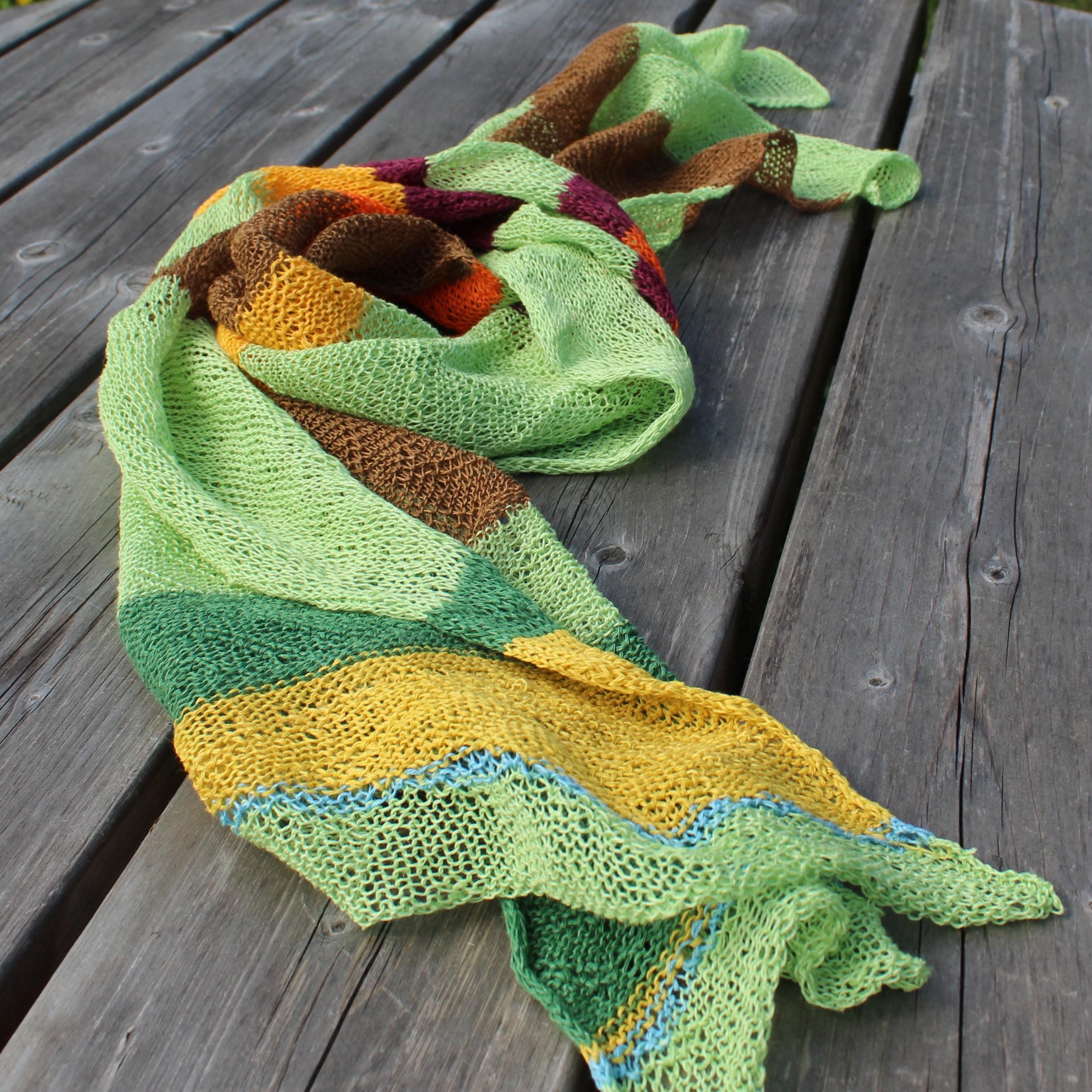 Colorful knitted scarf on a wooden surface