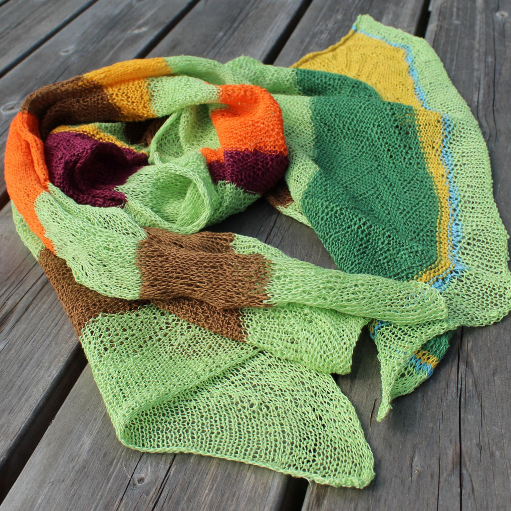 Colorful knitted scarf on a wooden surface