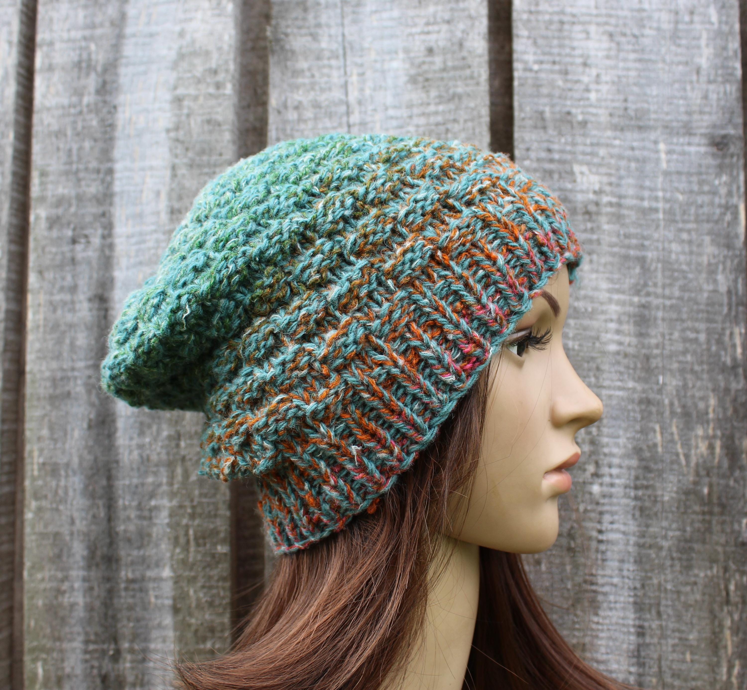 Knitted beanie on a mannequin head against a wooden background