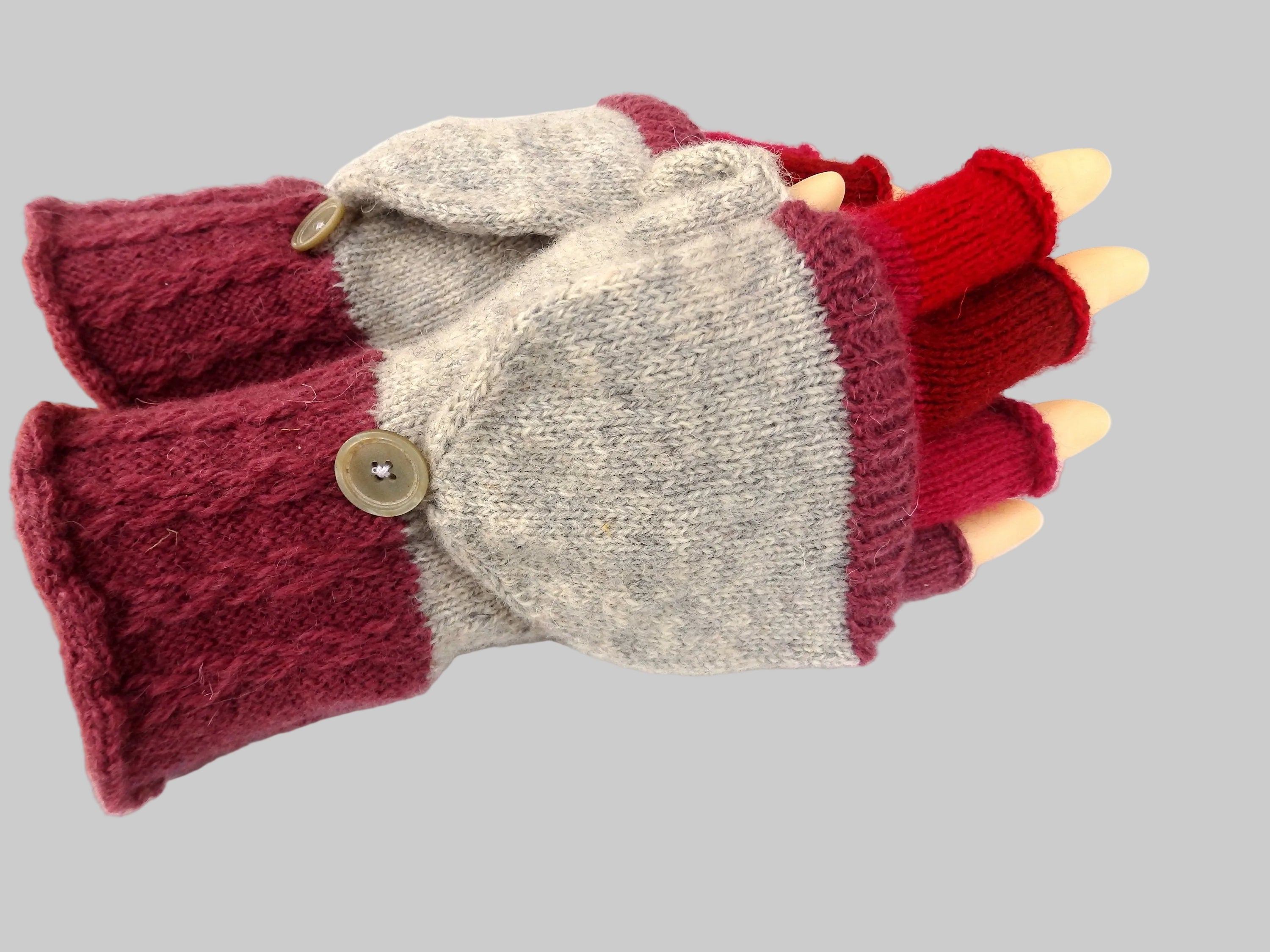 Knitted gloves with button closures on a white background