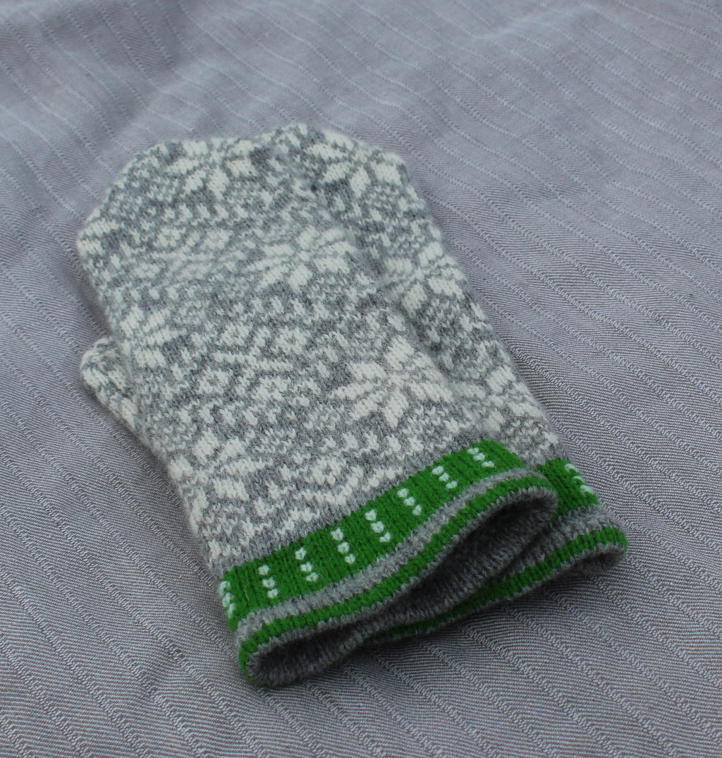 Knitted glove with a pattern on a gray fabric background