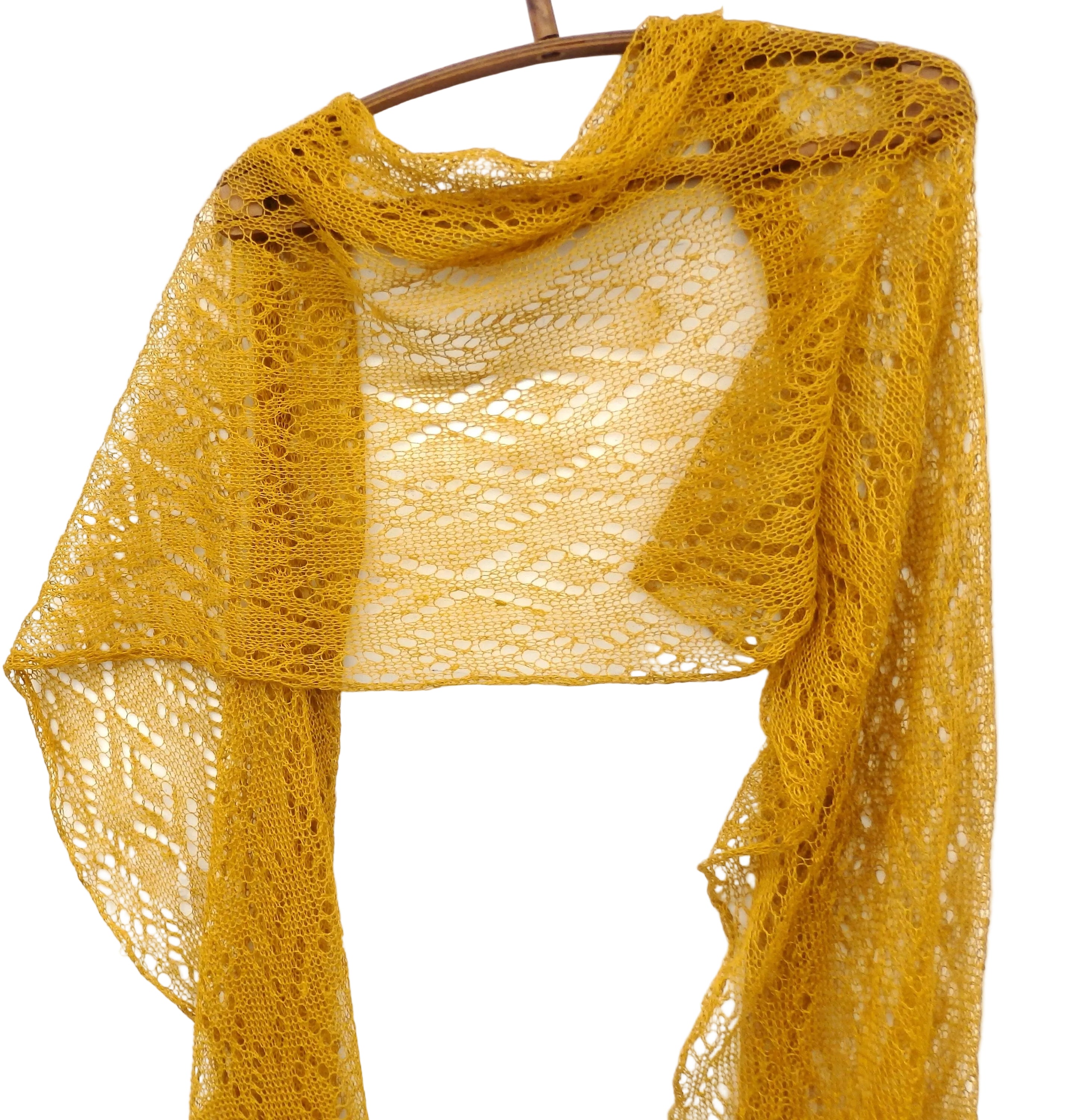 Yellow lace shawl on a wooden hanger against a white background