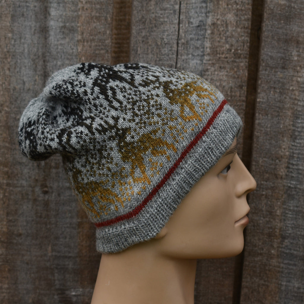Knitted beanie with a pattern on a mannequin head against a wooden background