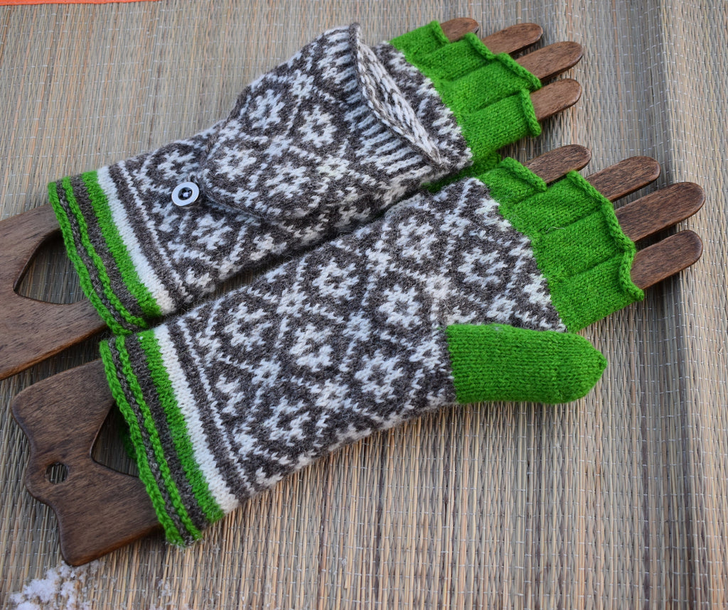 Pair of patterned gloves with green accents on a wooden surface