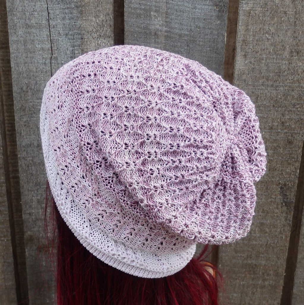 Lace-style headscarf worn by a person with red hair against a wooden background