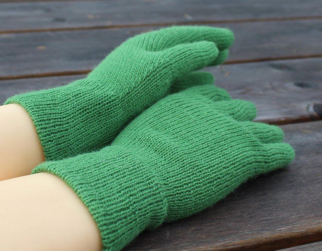 Green gardening gloves on a wooden surface