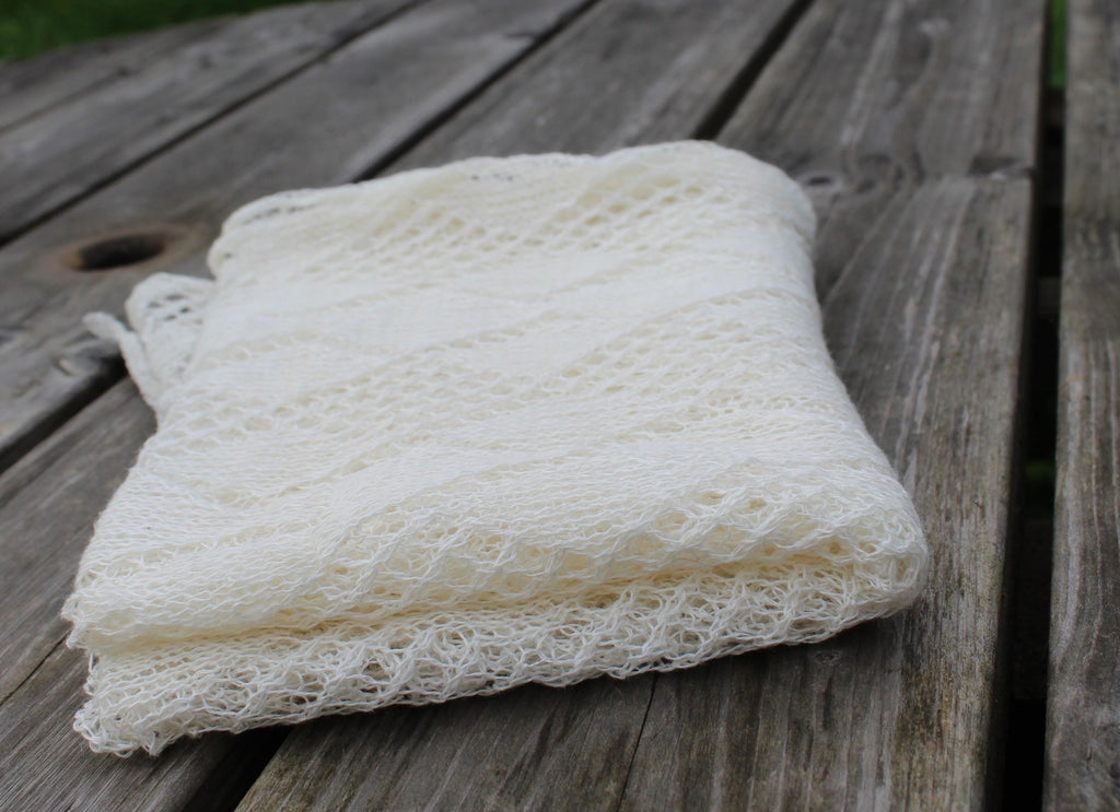Folded white loofah on a wooden surface