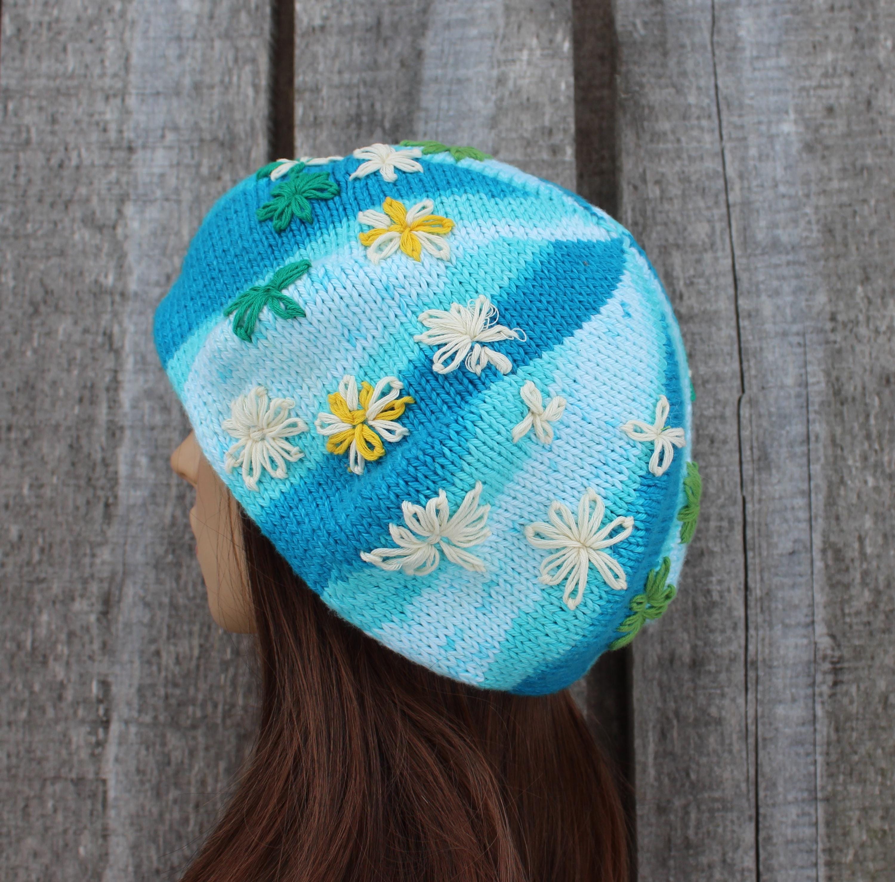 Knitted hat with floral patterns on a wooden background