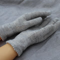 Gray gloves on a gray fabric background
