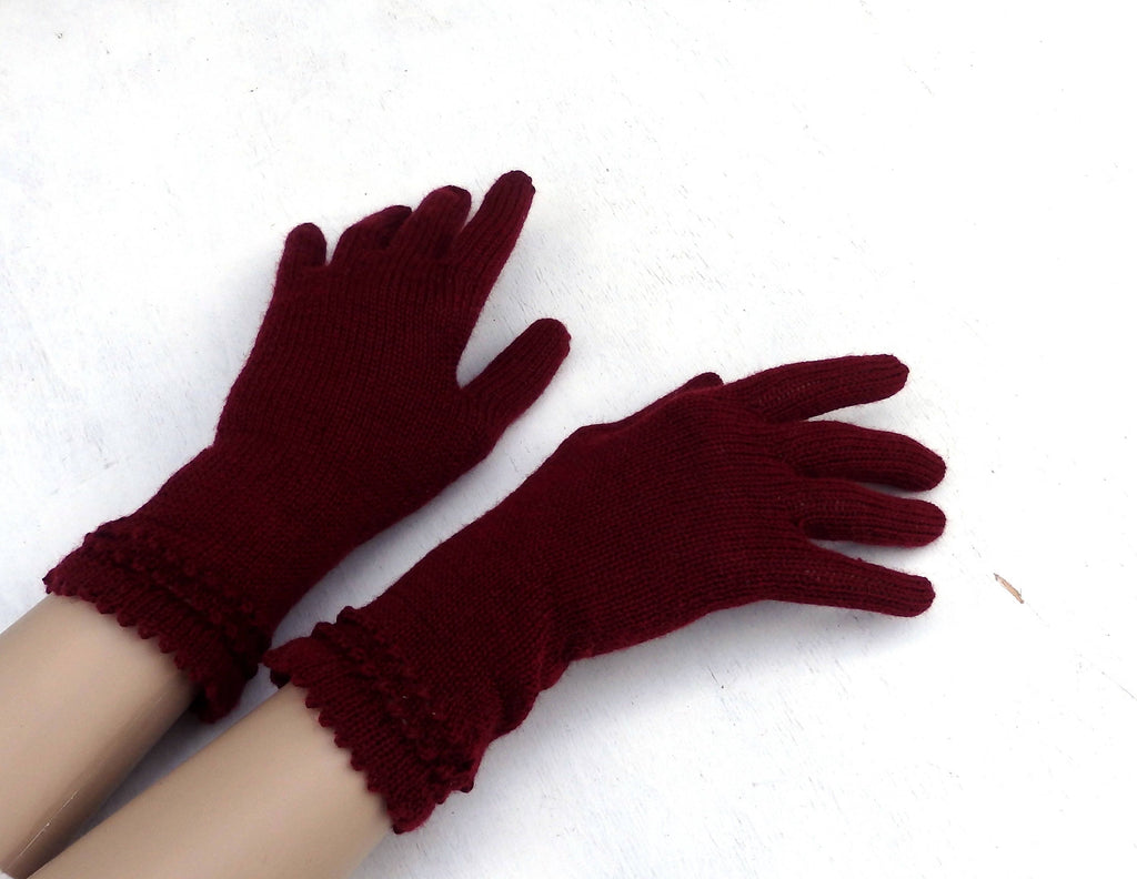 Pair of maroon gloves on a white background