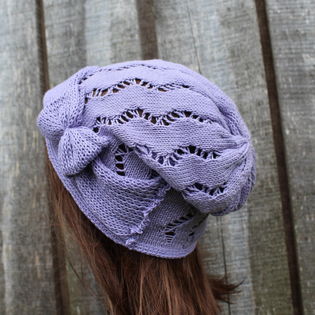Purple knitted headscarf on a person with wooden background