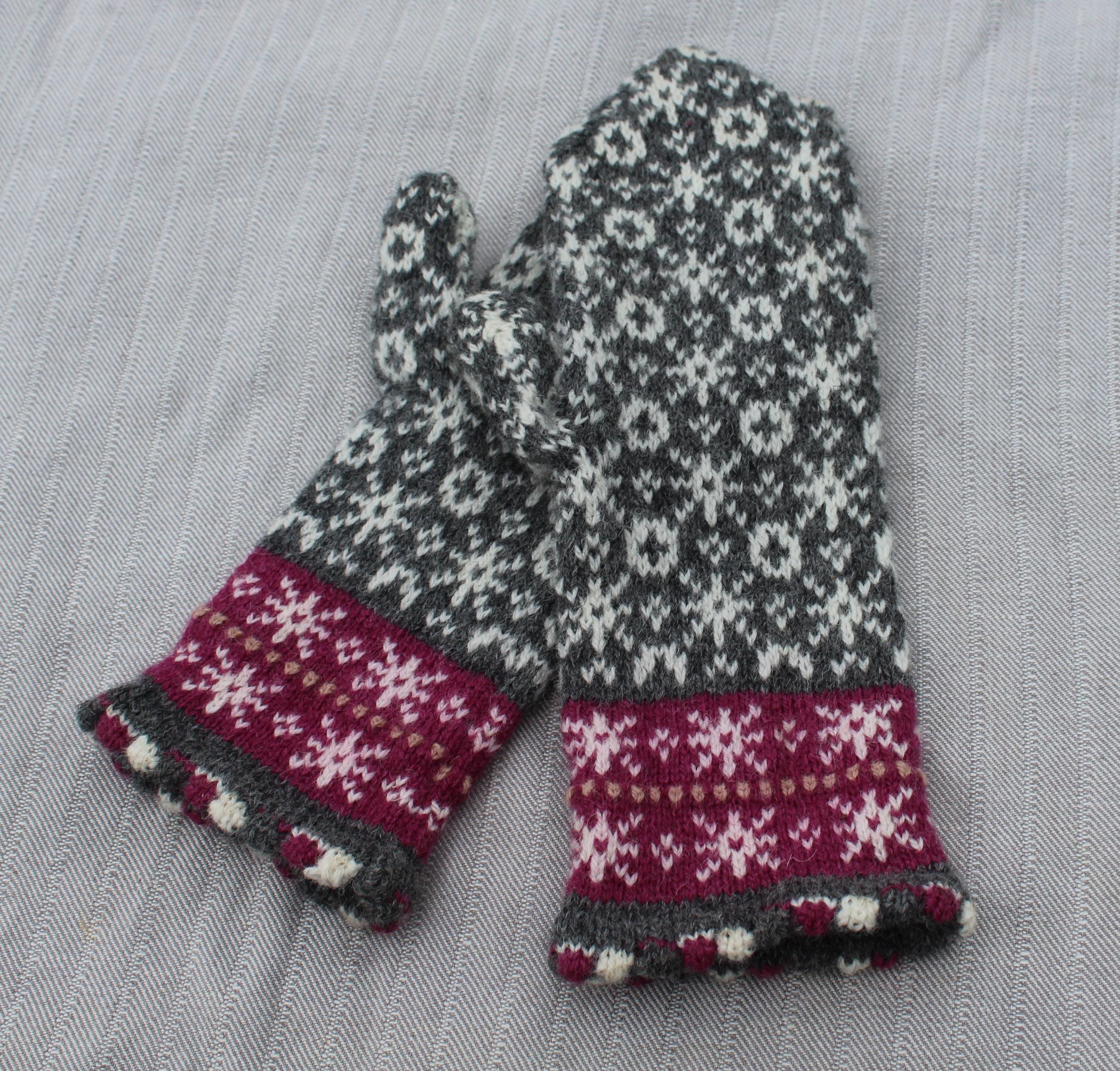 Pair of knitted gloves with a floral pattern on a gray background