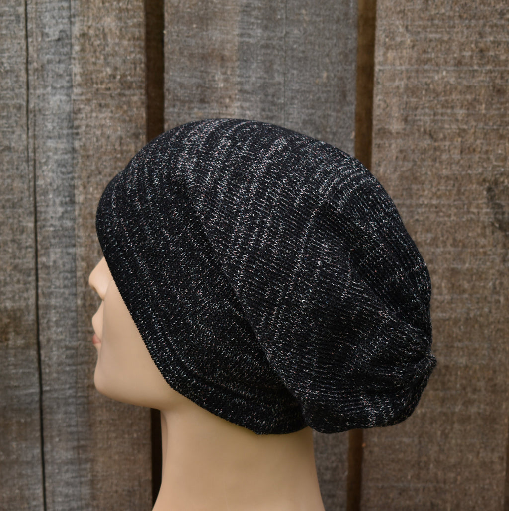 Black textured beanie on a mannequin head against a wooden panel background