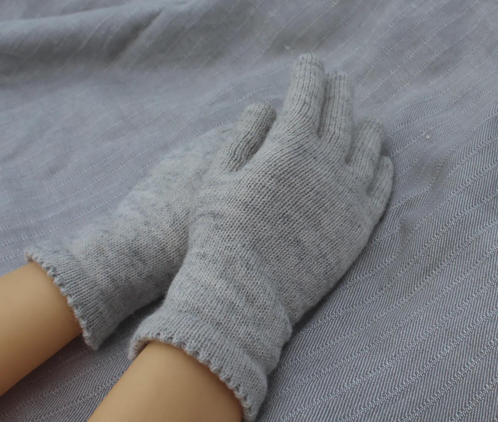 Gray gloves on a gray fabric background