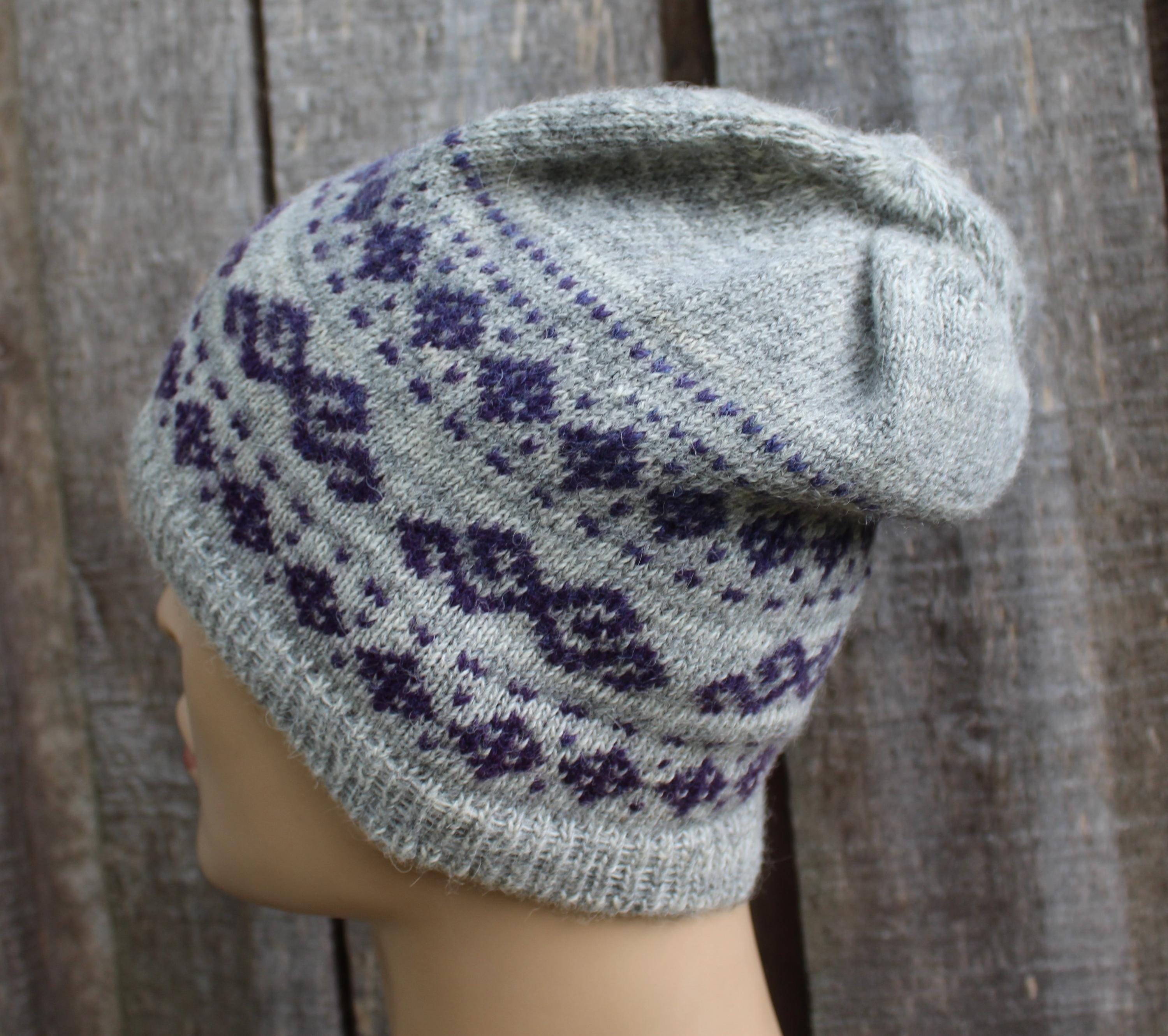 Knitted hat with a pattern on a wooden background